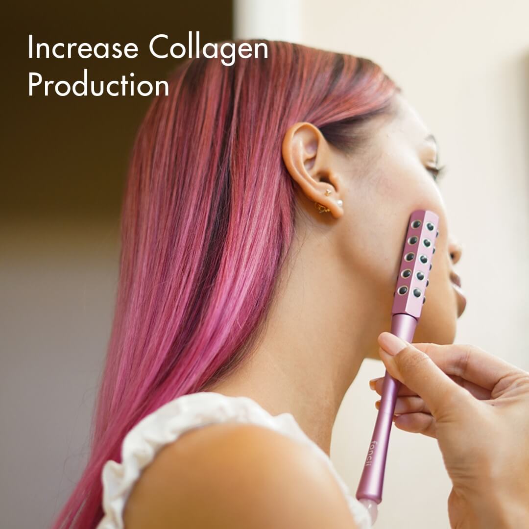 A person uses the purple Remi germanium facial roller on their cheek to increase collagen production.