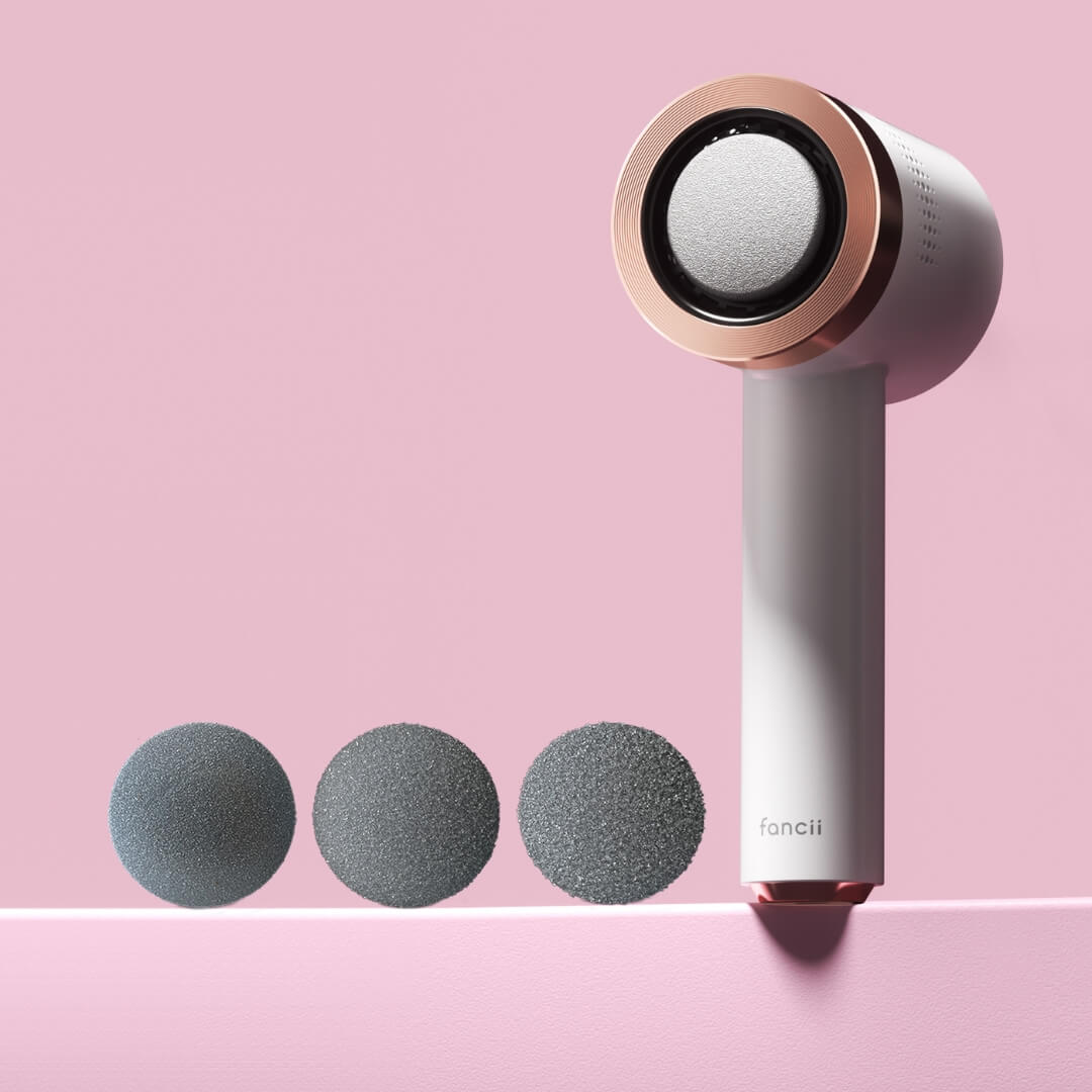 White and rose gold Cali Electric Callus Remover and foot file with three interchangeable grit pedicure roller heads.