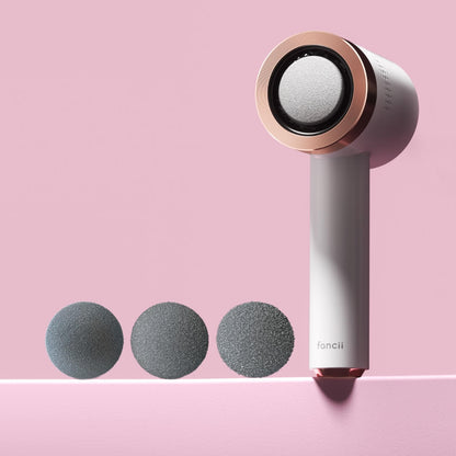 White and rose gold Cali Electric Callus Remover and foot file with three interchangeable grit pedicure roller heads.