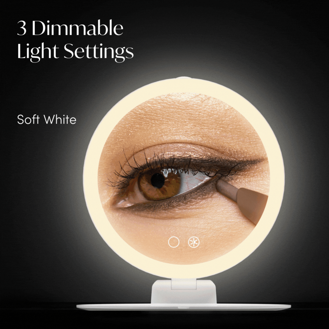 Abigail 10x magnification travel mirror with dimmable LED ring light showing a close-up for eye makeup application.