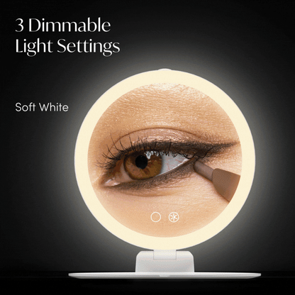 Abigail 10x magnification travel mirror with dimmable LED ring light showing a close-up for eye makeup application.
