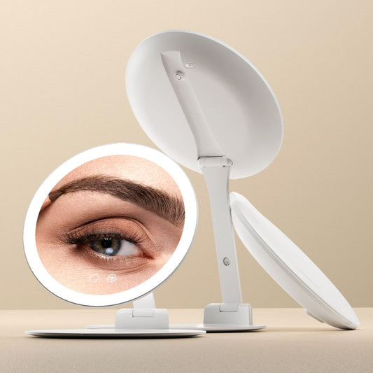 Abigail portable travel mirror with 10x magnification, LED ring light, and folding swivel stand for makeup application.