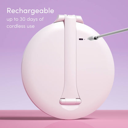 Abigail LED travel makeup mirror in white being charged via USB cable on a lavender background.