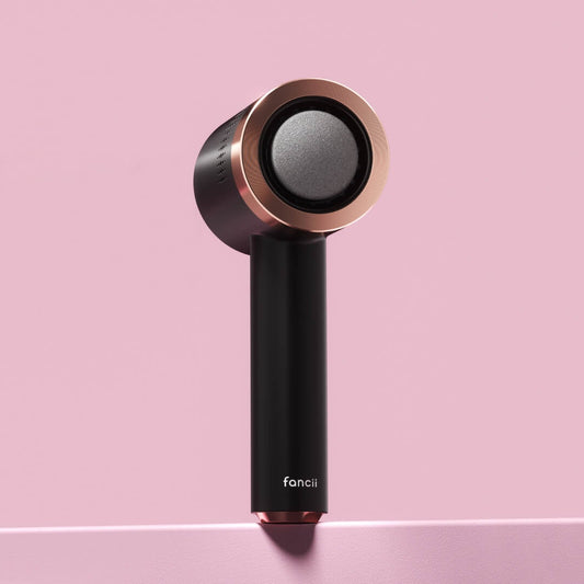 Cali Electric Callus Remover by Fancii in black and rose gold, professional electric foot file on a pink background.