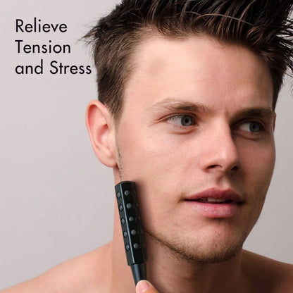 Man using the Remi Uplift germanium-infused facial massage roller on his jaw to relieve tension and stress.