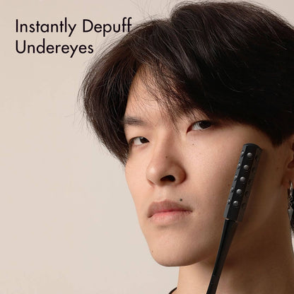 Man using Remi Uplift Facial Massage Roller with germanium stones to instantly depuff undereyes.