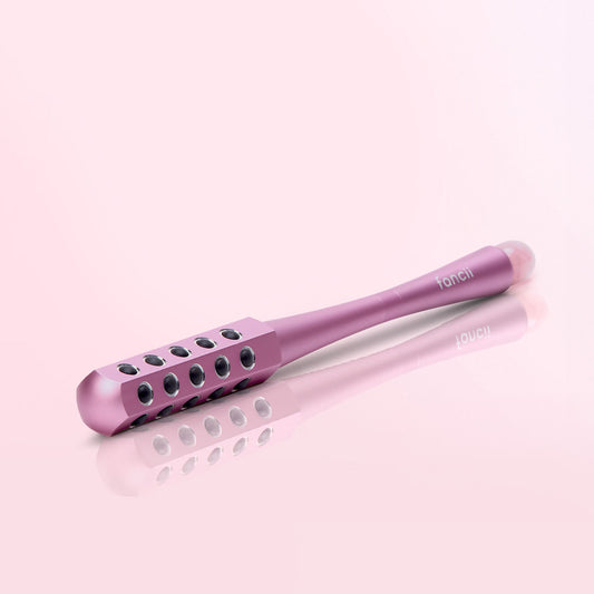 Remi Uplift Facial Massage Roller with germanium stones and gua sha end for firming and depuffing skin.