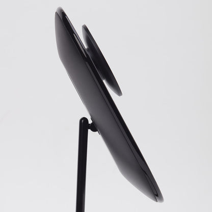 Side view of the Lara 10x magnifying mirror magnetically attached to the back of the black Vera vanity mirror.