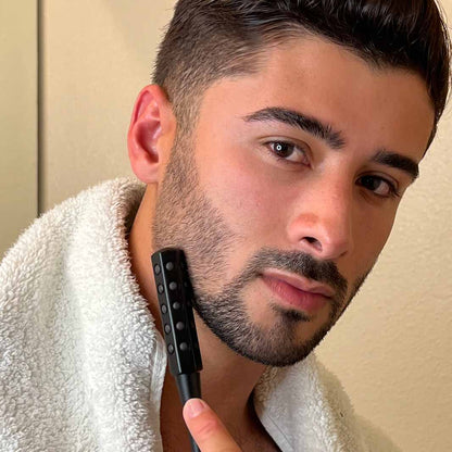 Man using Remi Uplift Facial Massage Roller with germanium stones on his jawline to firm and tighten skin.
