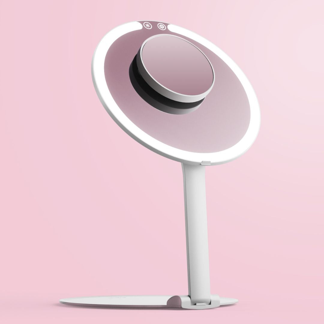 Abigail LED travel makeup mirror in white with ring light and adjustable stand against a pink background.