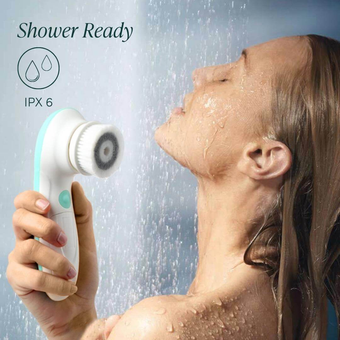 IPX6 waterproof Cora 7 electric face and body cleansing brush used by a woman in the shower for exfoliation.