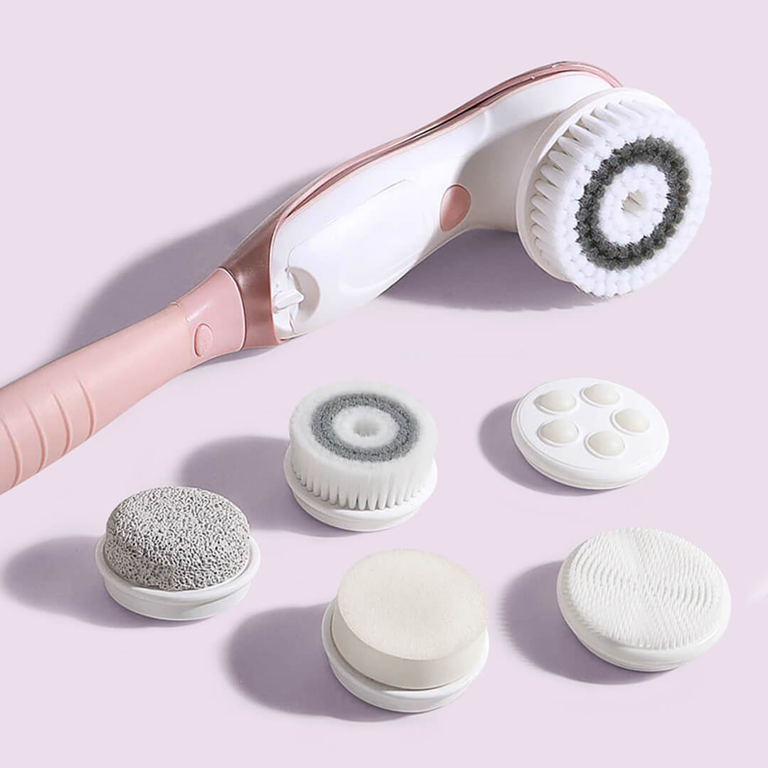 Cora 7 electric body cleansing brush set with detachable pink handle and six interchangeable exfoliating brush heads.