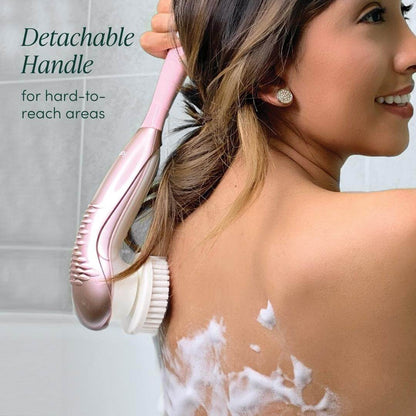 Woman using the Cora 7 pink electric body cleansing brush with its detachable handle to exfoliate her back in the shower.