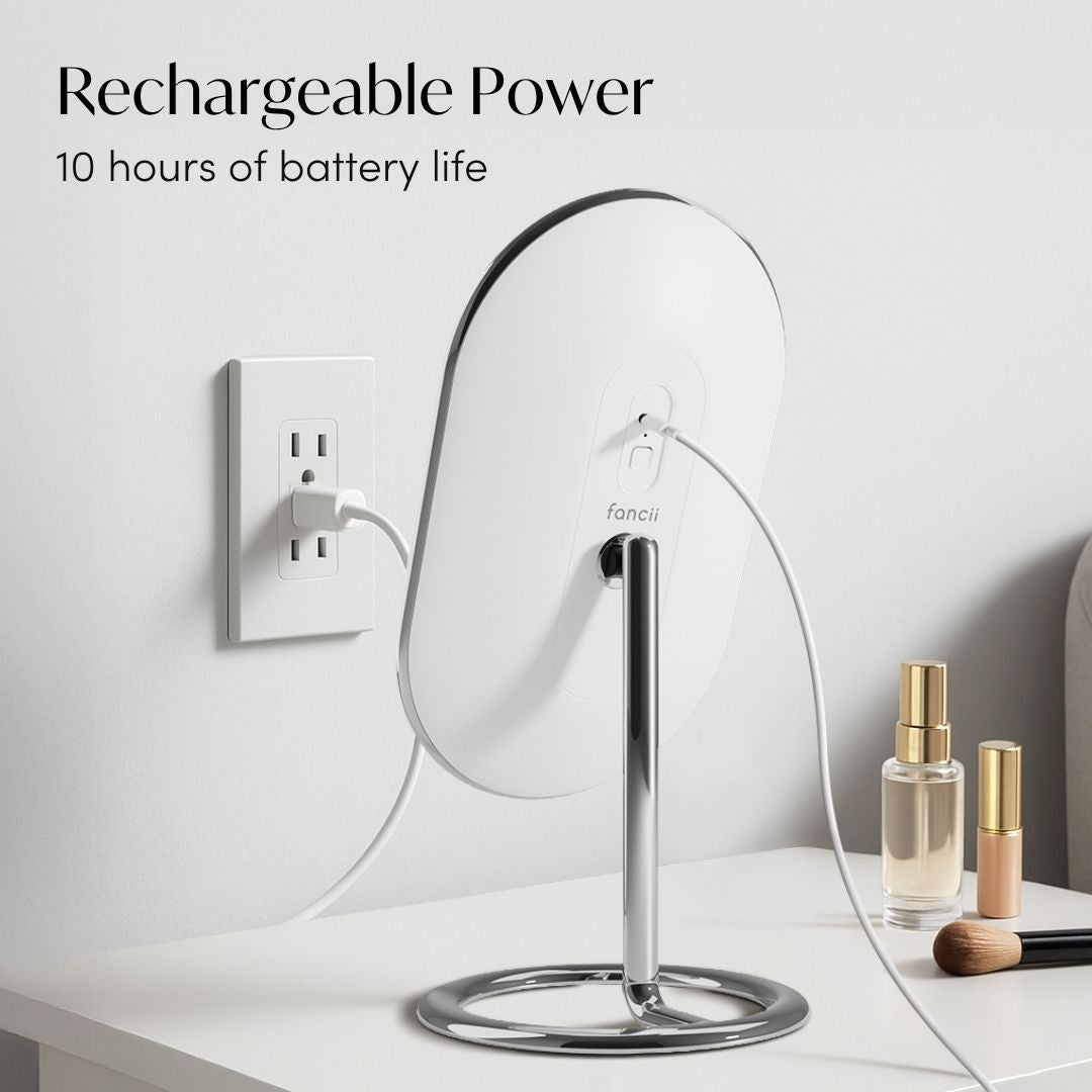 Vera rechargeable lighted vanity mirror plugged into a wall outlet, showcasing 10-hour battery life on a white desk.