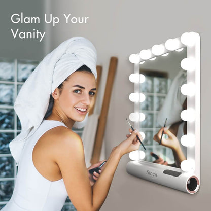 Madeline Mini Hollywood Mirror with LED lights and Bluetooth speaker, used by a woman for makeup application.
