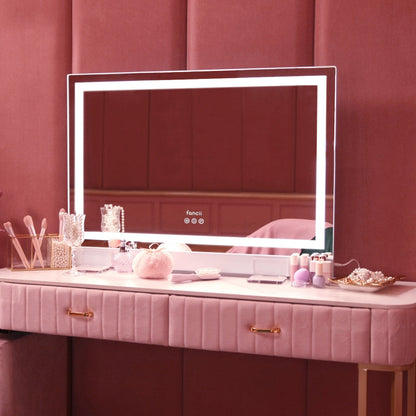 Monroe Hollywood Vanity Mirror with LED Omni-Glow lights on a pink velvet makeup desk with professional accessories.