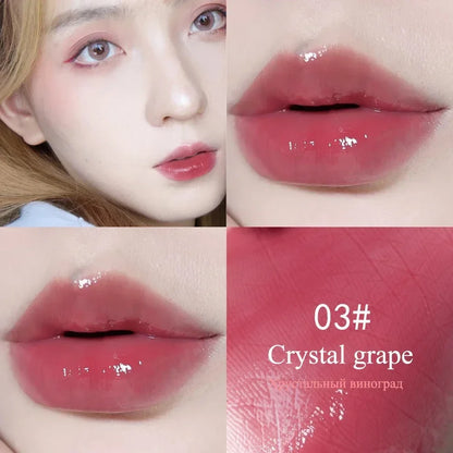 High-shine LuxeGloss in 03 Crystal Grape on lips, showing a vibrant, waterproof mauve-pink tint with a radiant finish.