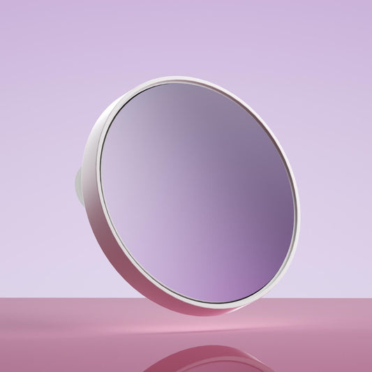 Fancii Tara 10x Magnifying Mirror with white frame and suction mount, floating against a purple background.