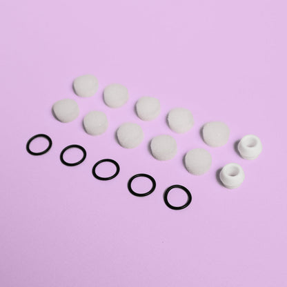 Clara Essential Kit replacement parts: 10 white foam suction filters, 5 black rubber rings, and 2 silicone tips.
