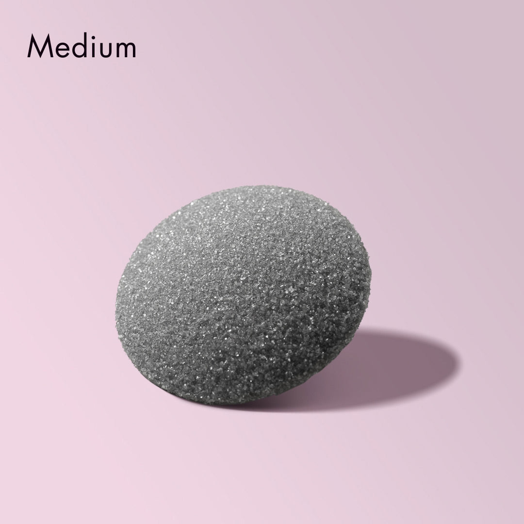 Medium grit Cali callus remover replacement head for foot pedicure tool, featuring textured gray surface on pink background.