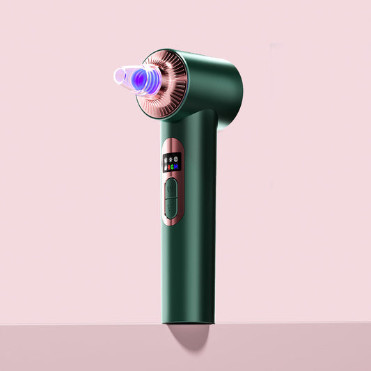 Clara Microdermabrasion Device in emerald green with LED light therapy and pore vacuum suction for blackhead removal.