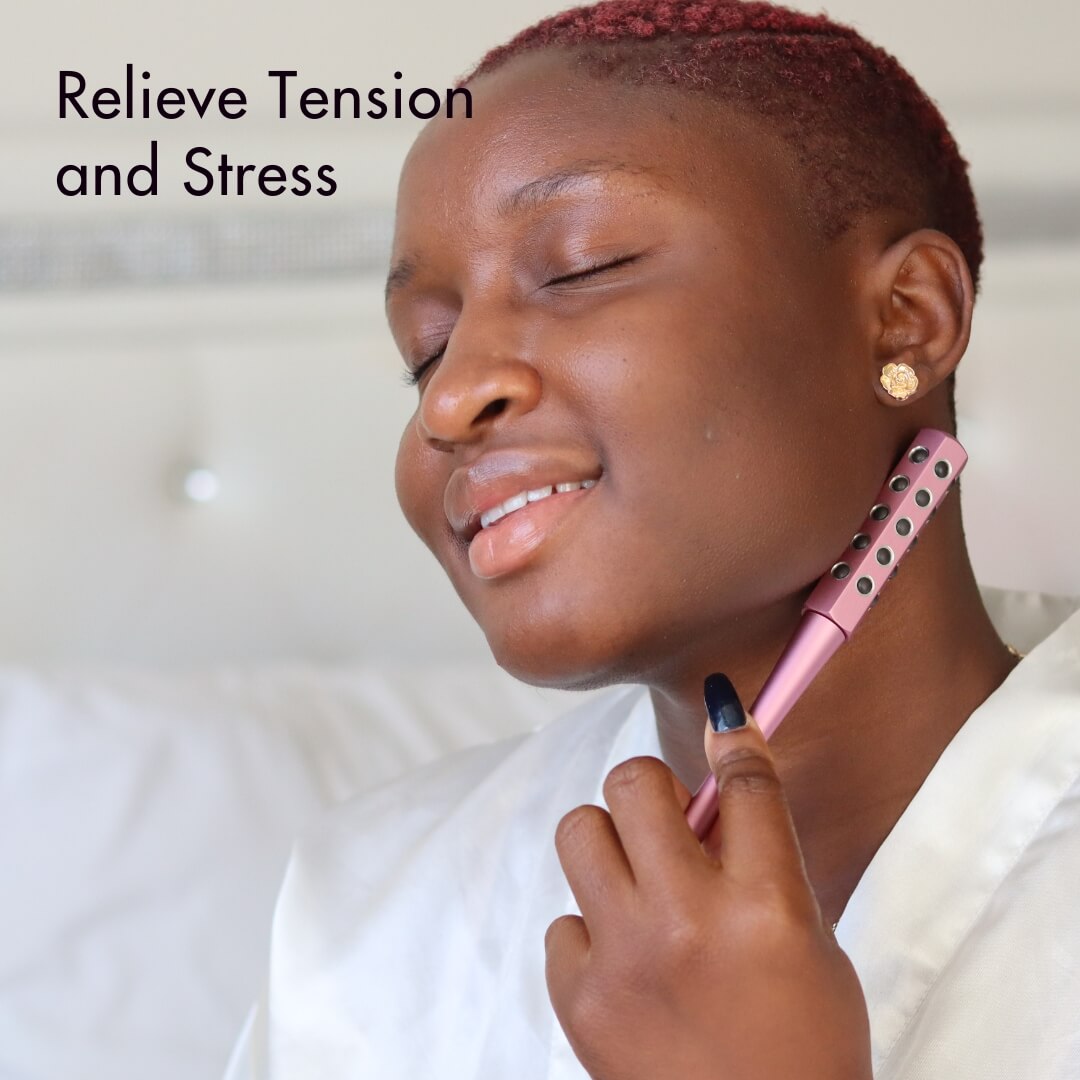 Woman uses pink Remi germanium facial roller on neck to relieve tension and stress for better skin elasticity.