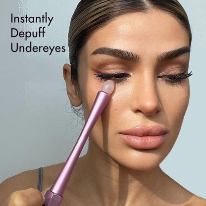 Model using the Remi Uplift Facial Massage Roller's gua sha stone tip to depuff undereyes for firmer skin.