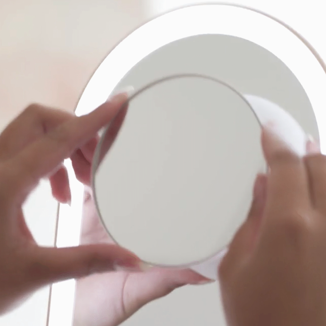 Lara 10x magnifying mirror attachment magnetically clipping onto the Vera vanity mirror for makeup and skincare.