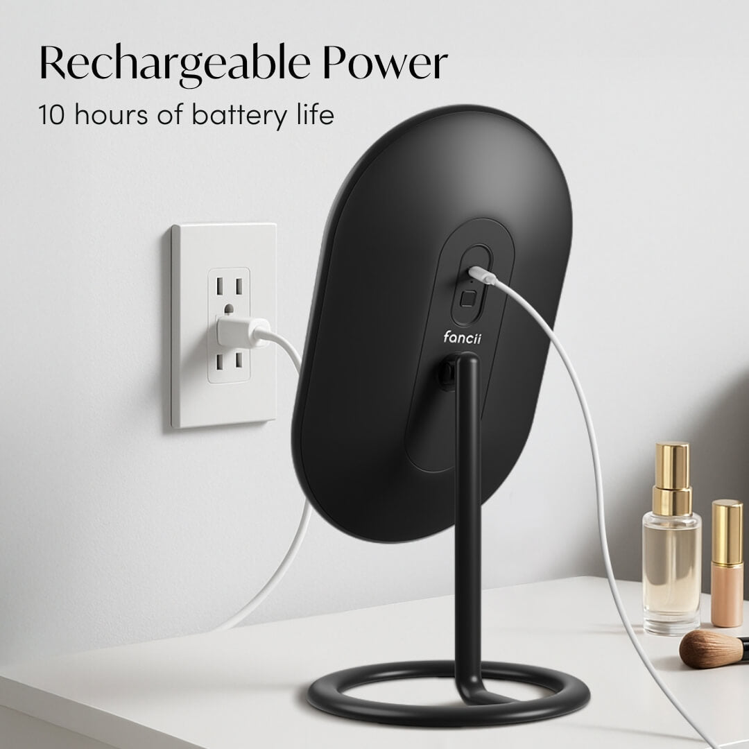 Rechargeable Vera lighted vanity mirror in black charging via USB cable, featuring 10 hours of battery life.