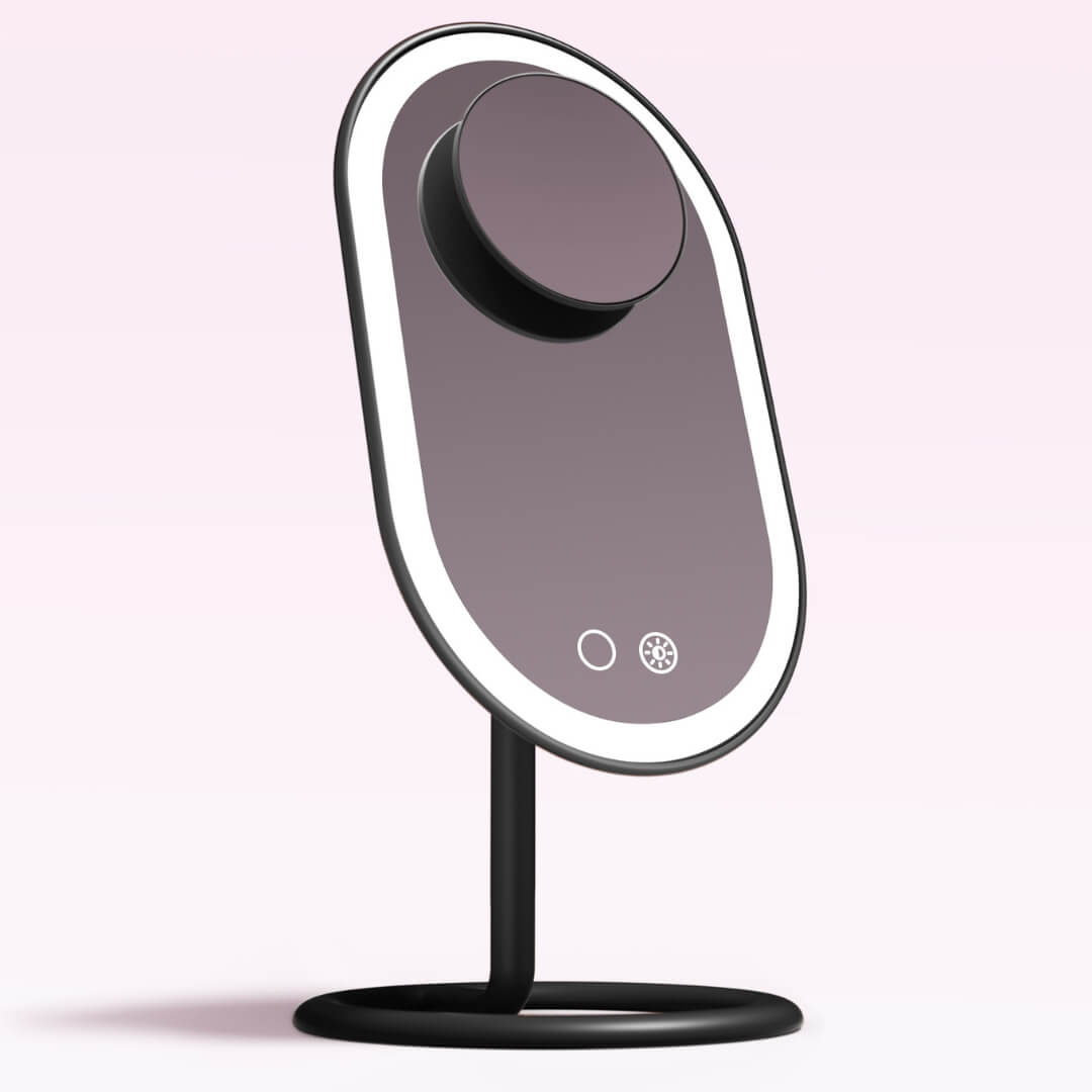 Vera LED makeup vanity mirror with Tru Glow lighting and magnetically attached Lara 10x magnifying mirror on black stand.
