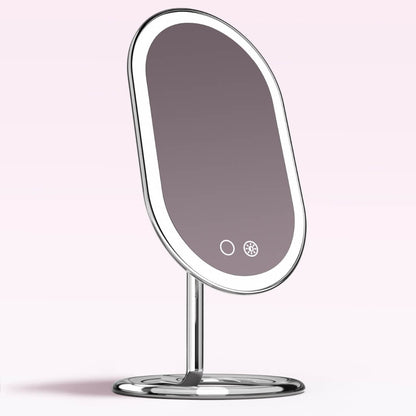 Vera Lighted Vanity Mirror with sleek aluminum finish, LED light ring, and touch sensors on a sturdy silver base.